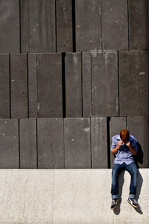 Boy crying by a wall